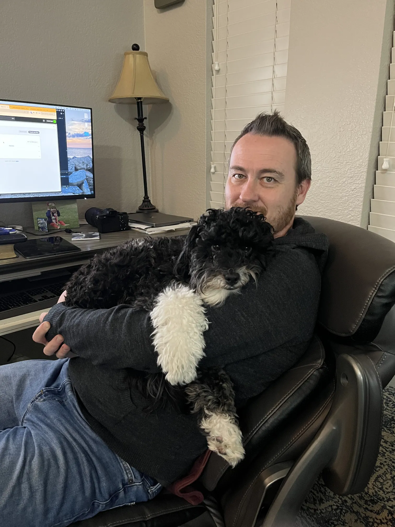 Nathaniel at his desk with his dog